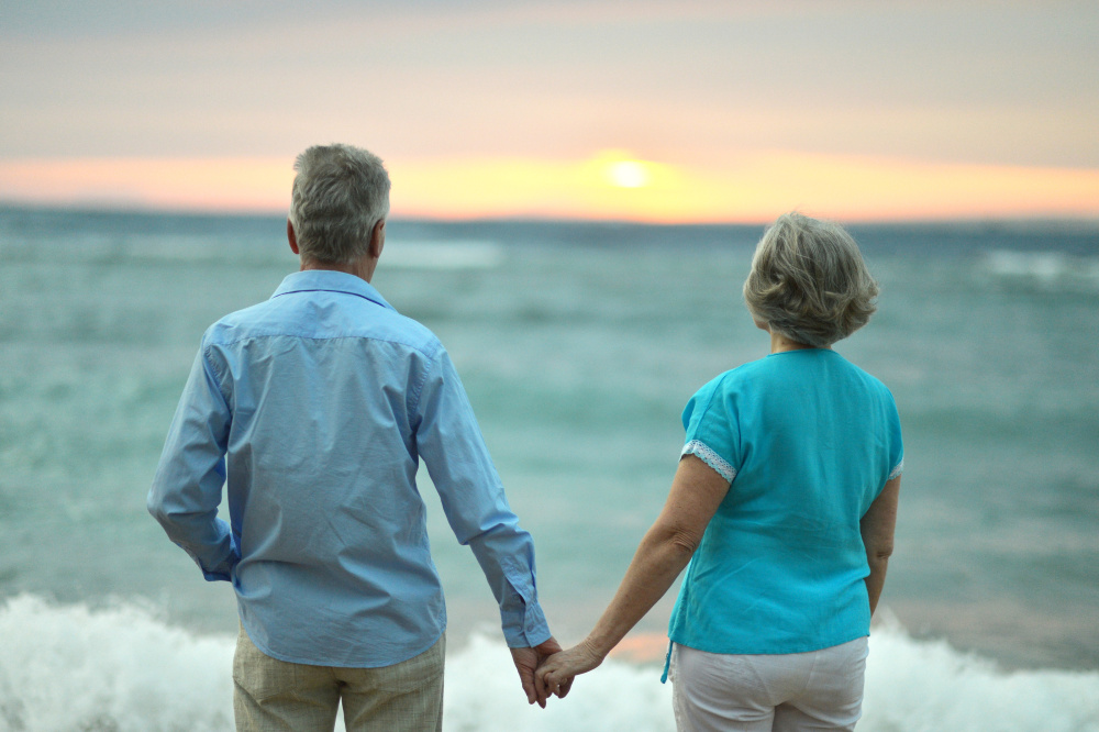 Amusing elderly couple on a beach