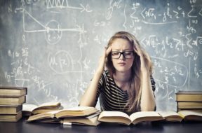 Beautiful blonde girl stressed by the study