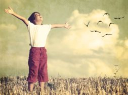 Colorized kid breathing fresh air with birds flock flying in bac