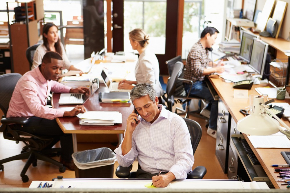 Interior Of Busy Architect’s Office With Staff Working