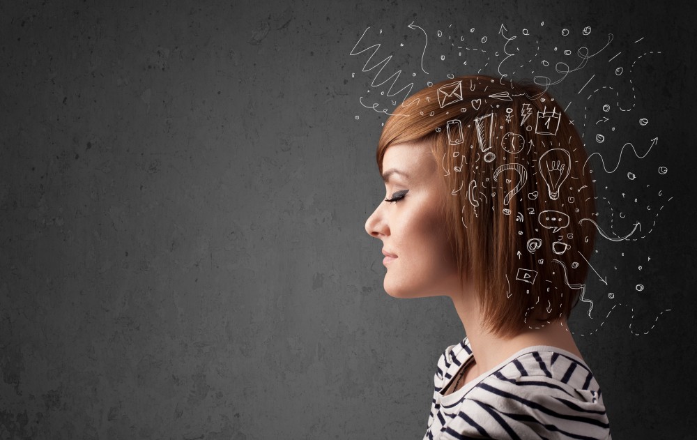 Young girl thinking with abstract icons on her head