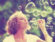 a pretty girl blowing bubbles – vintage toned with a retro insta