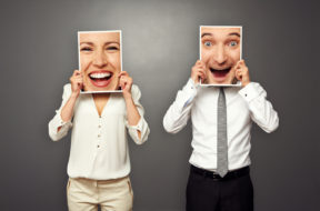 man and woman holding frames with big excited faces