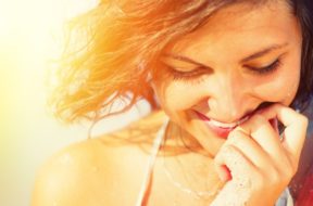 Beauty Sunshine Girl Portrait. Happy Woman Smiling and looking D