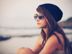 Fashion portrait of young hipster woman with hat and sunglasses